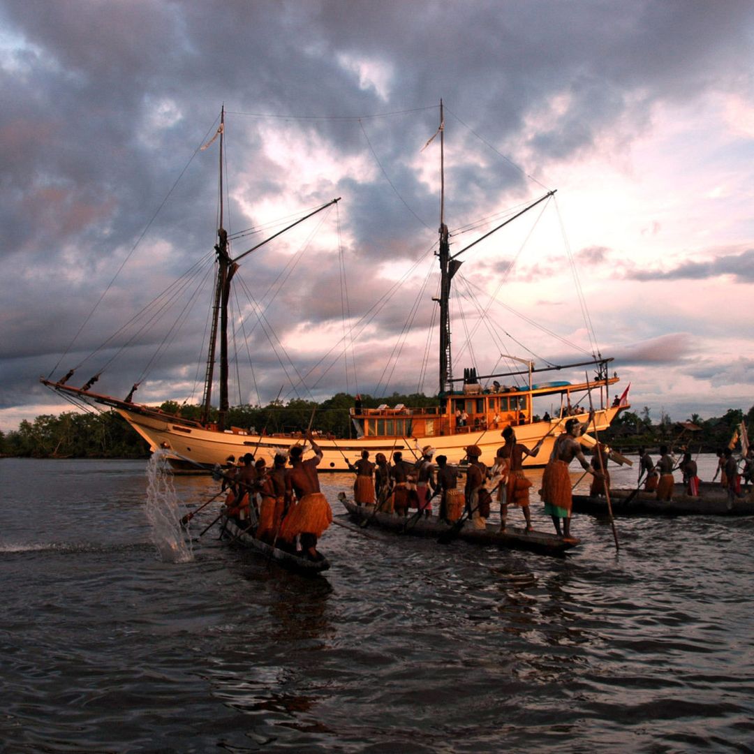 Papua, Asmat regency; a fleet of Asmat canoes with warriors in traditional dress  greets Silolona on arrival at Syuru village, Agats