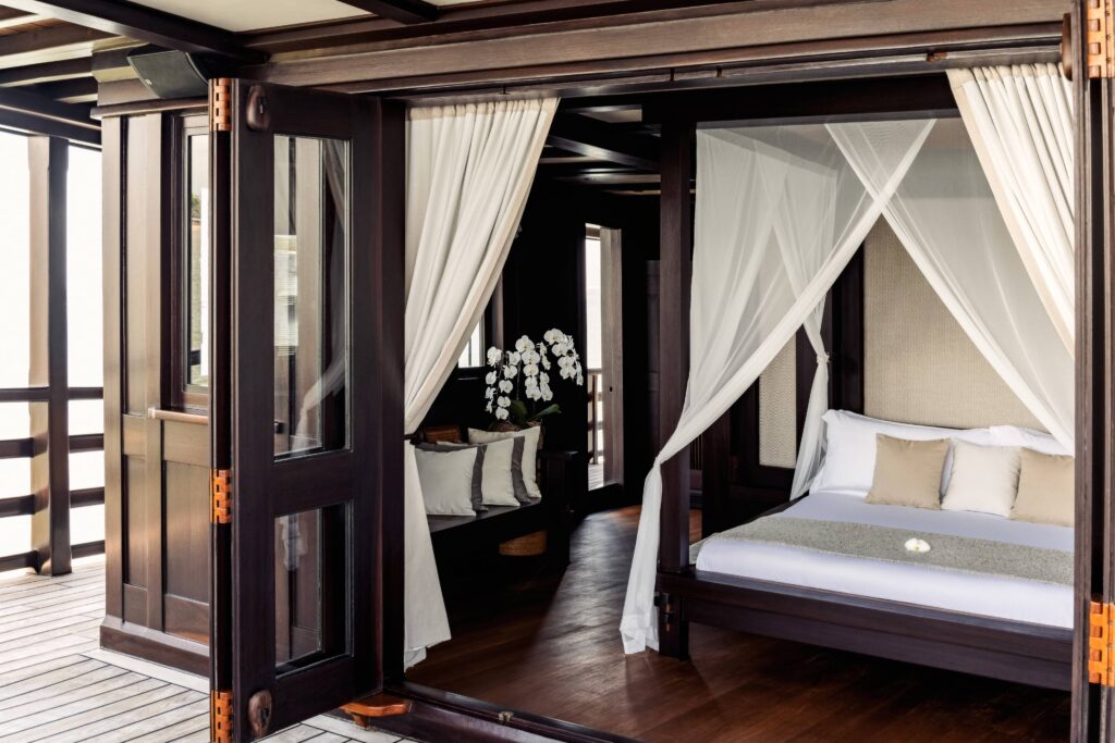Stunning master cabin with private balcony on Dunia Baru yacht in Indonesia